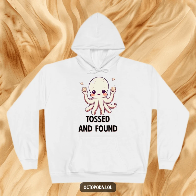 Funny octopus hoodie featuring a playful octopus character juggling small seashells, ideal for cozy and whimsical relaxation.